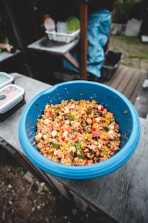 Close-up of assorted couscous grains in rustic bowls on a wooden table