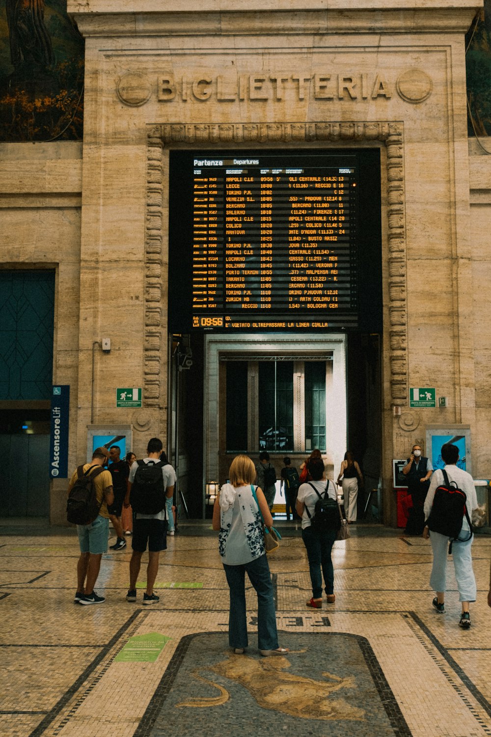 a group of people walking in front of a building