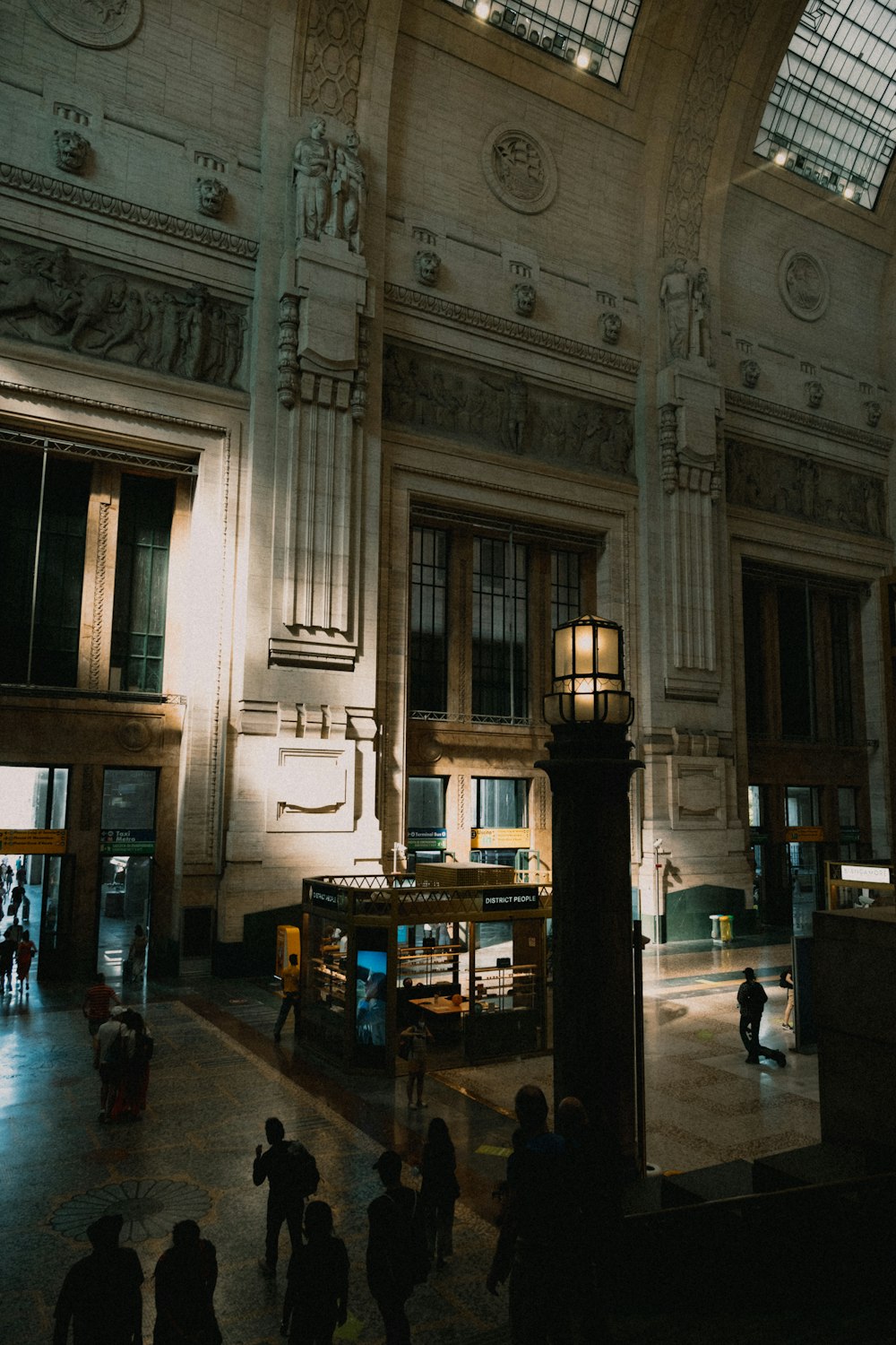 a large building with many windows and people walking around