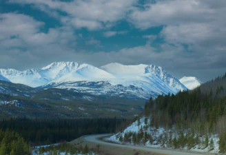 a river running through a snowy mountainous region