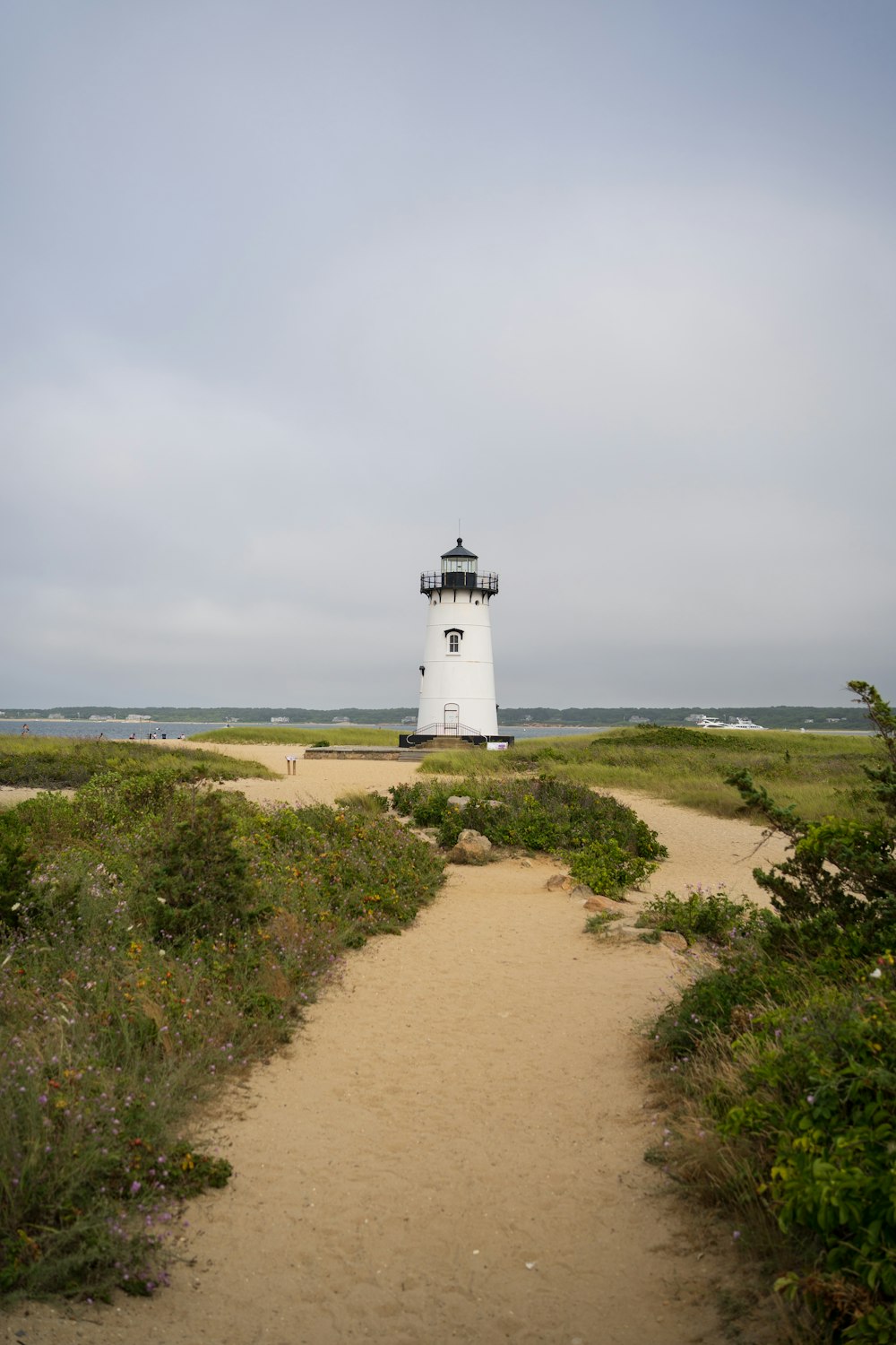 a lighthouse on a dirt path