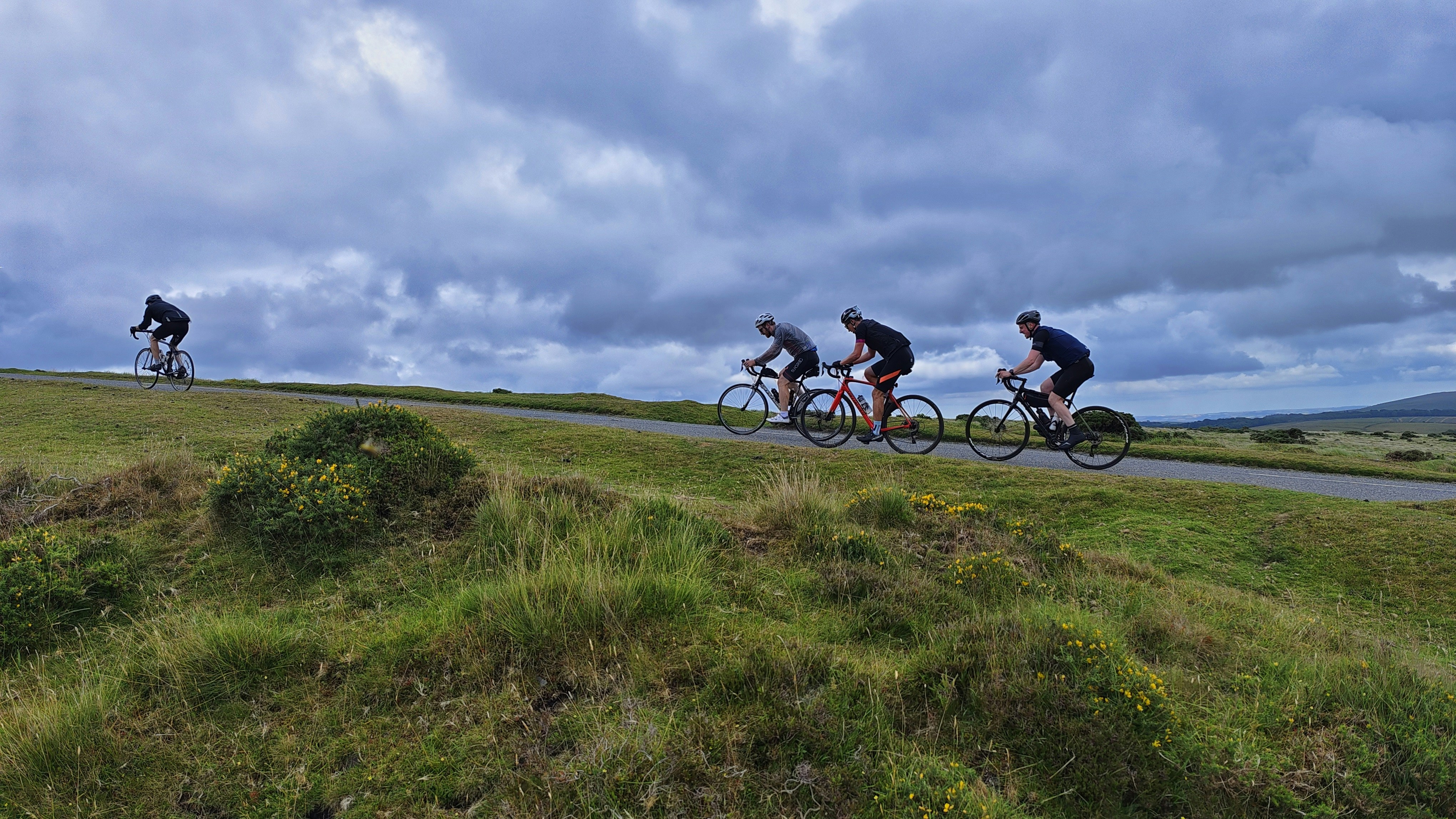 a group of people riding bikes on a road