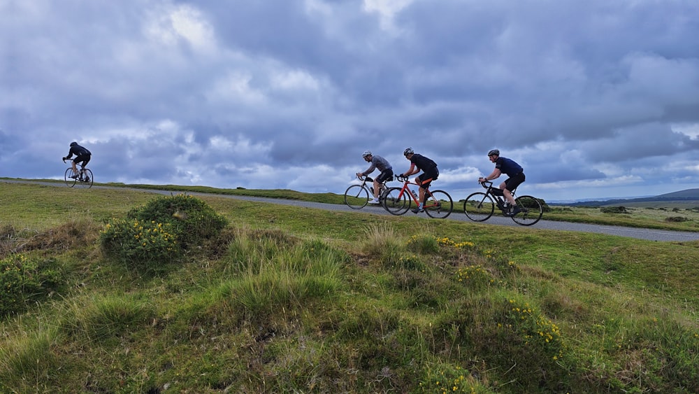 a group of people riding bikes on a road