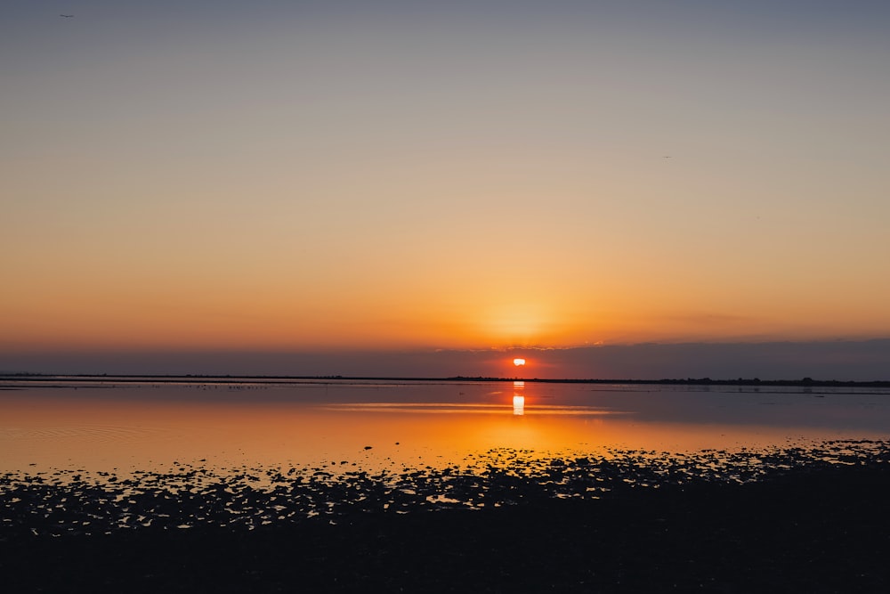 a sunset over a body of water