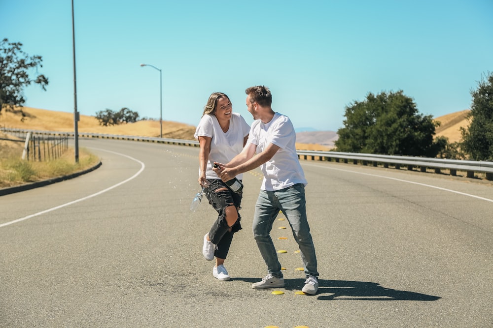 a man and woman walking down a road