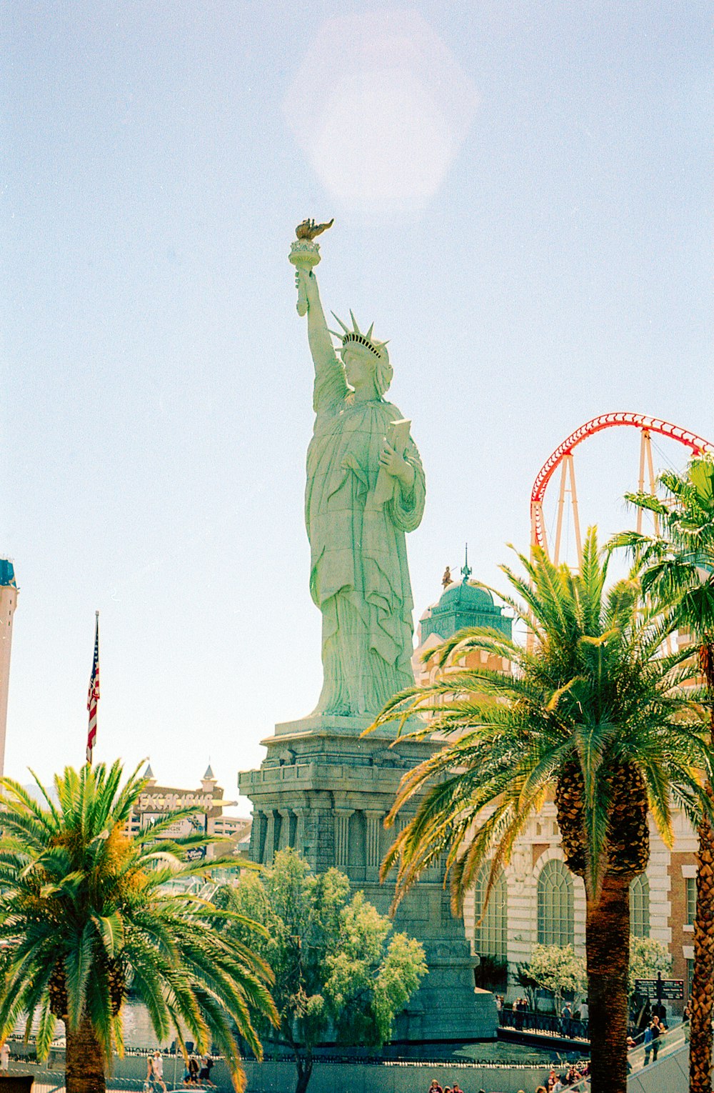 a statue of a person holding a torch in front of a large building