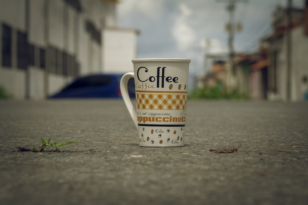 a coffee cup on a sidewalk