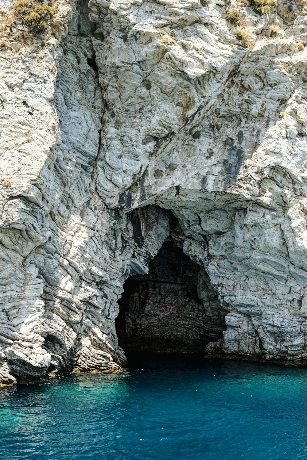 a cliff with a body of water below