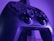 Close-up of a sleek gaming setup with purple and black theme, highlighting a glowing controller.