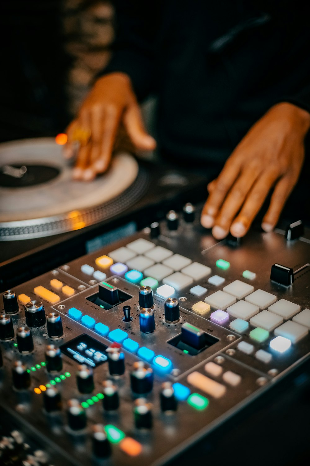 a dj mixer with a hand on the turntable