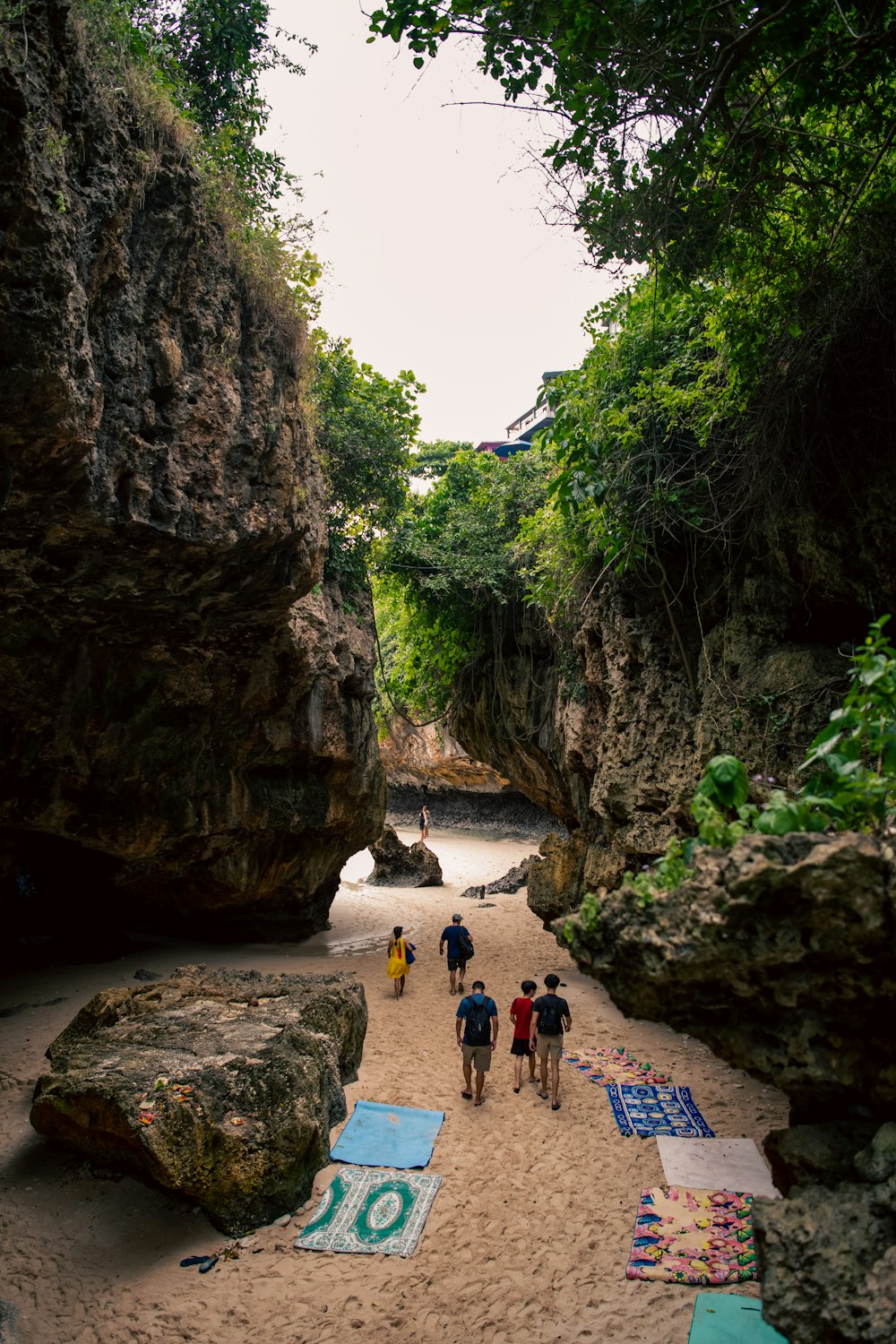 people walking on a path between rocks