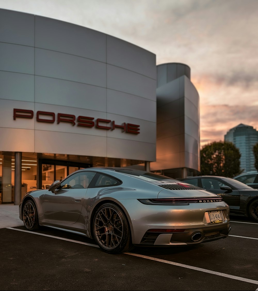 a silver sports car parked outside a building