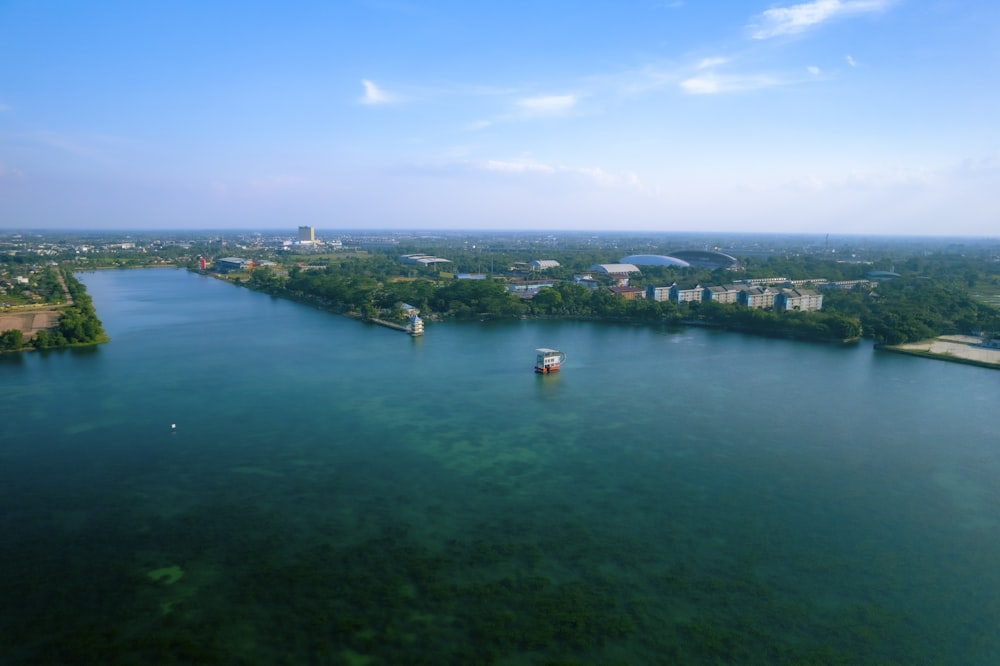 a body of water with boats and buildings in the background