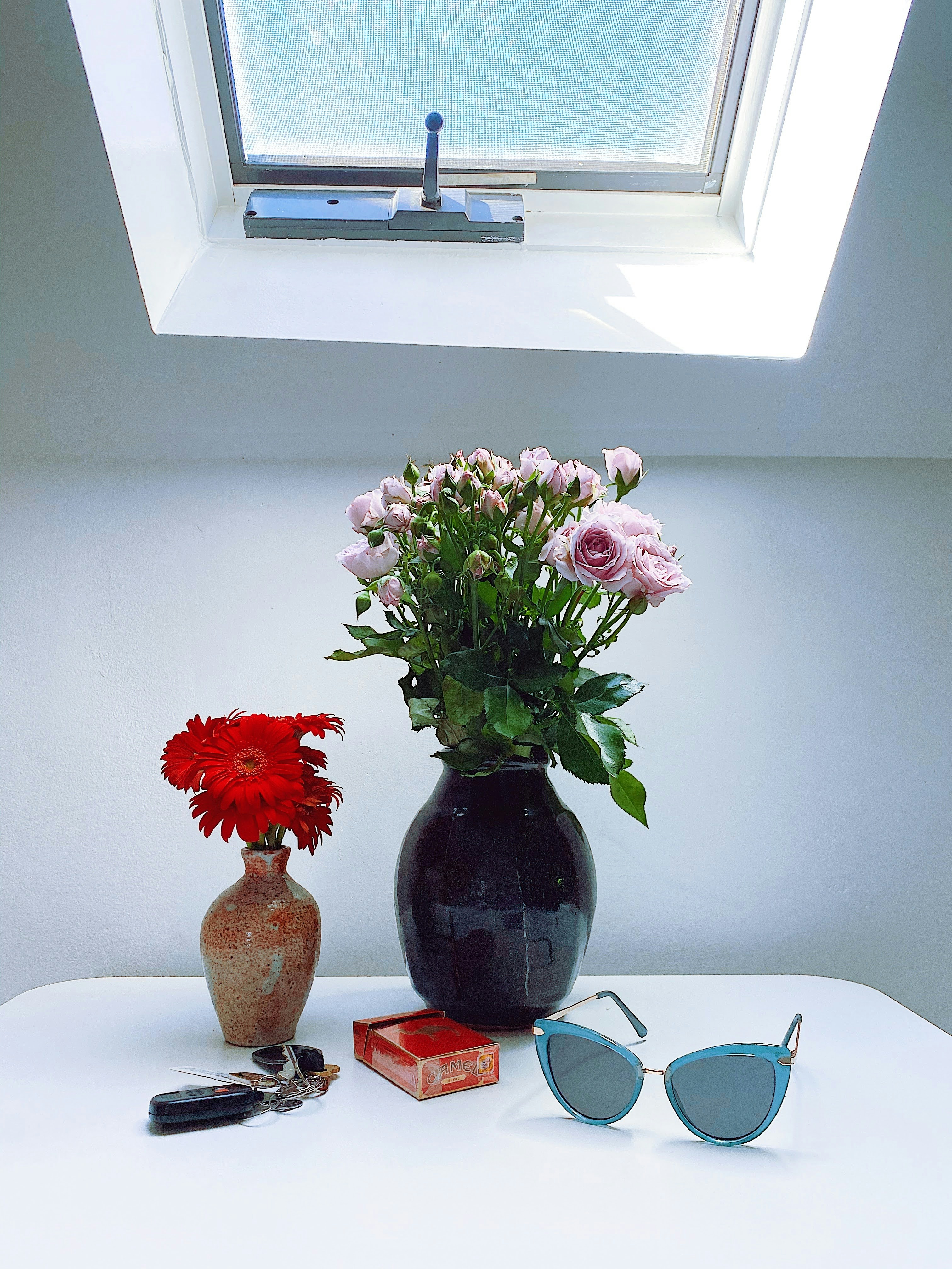a couple of vases with flowers
