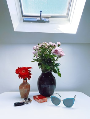 a couple of vases with flowers
