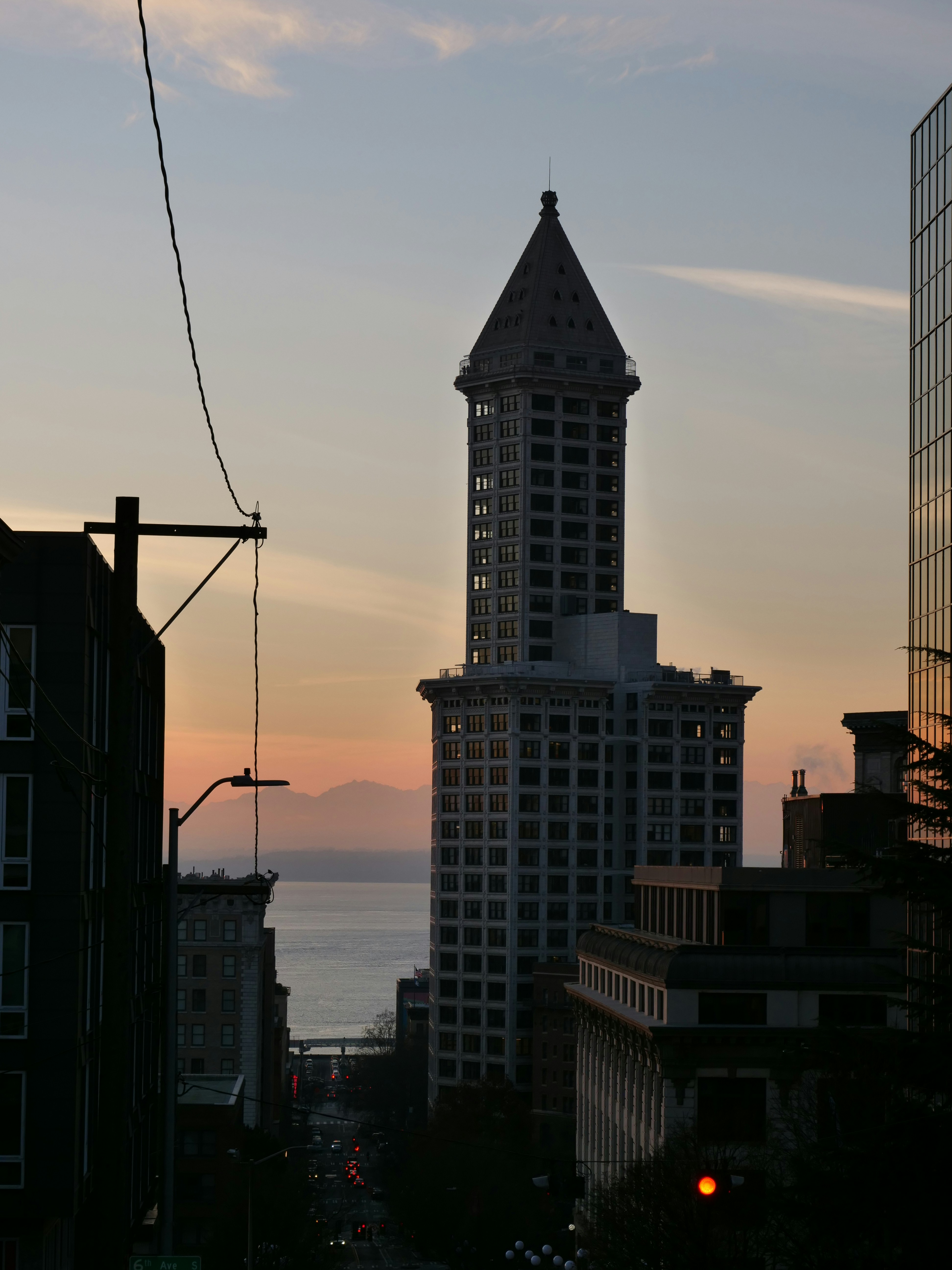 A tall building with a pointy top with Smith Tower in the background ...