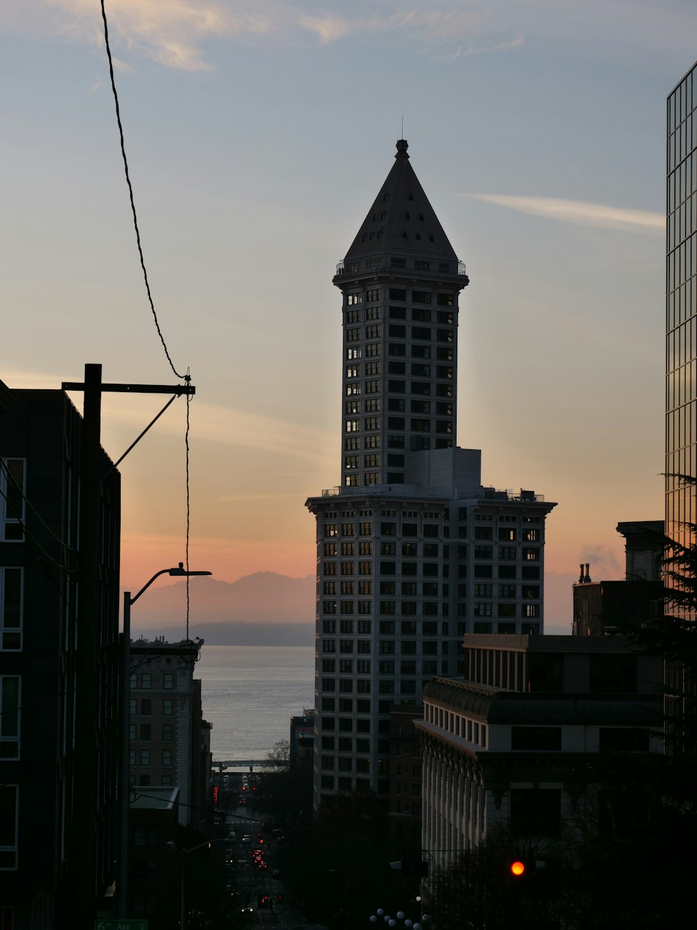 a tall building with a pointy top with Smith Tower in the background