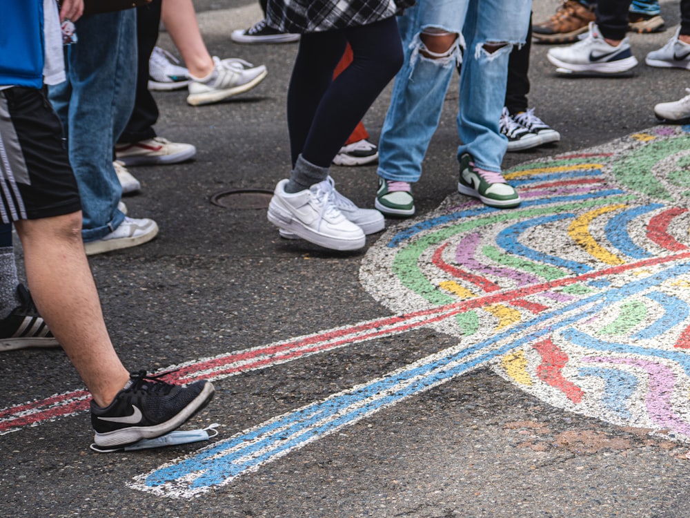 a group of people standing on a colorful floor