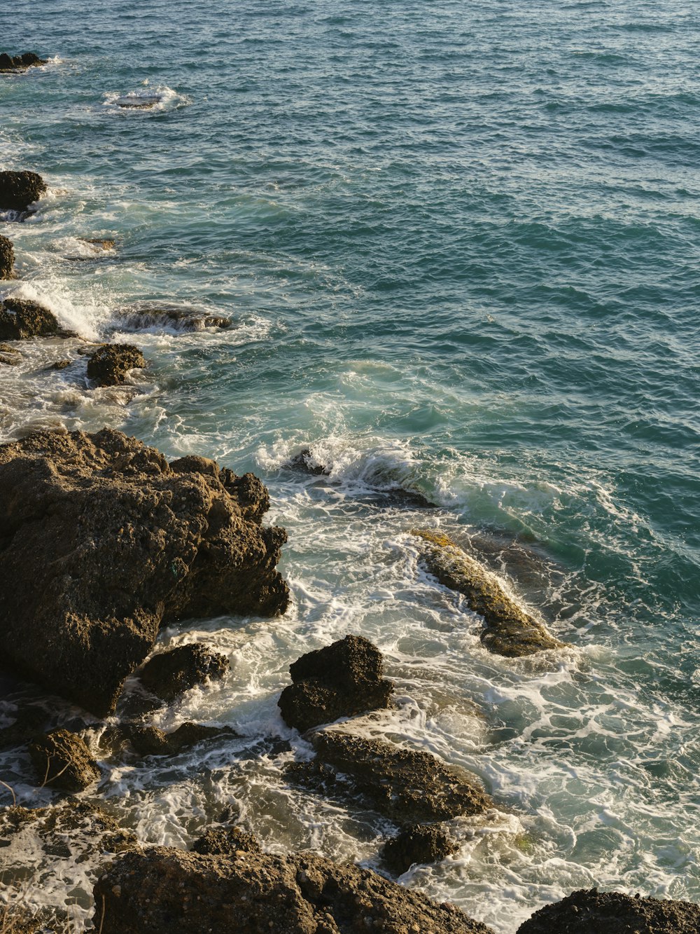 a rocky beach with waves crashing