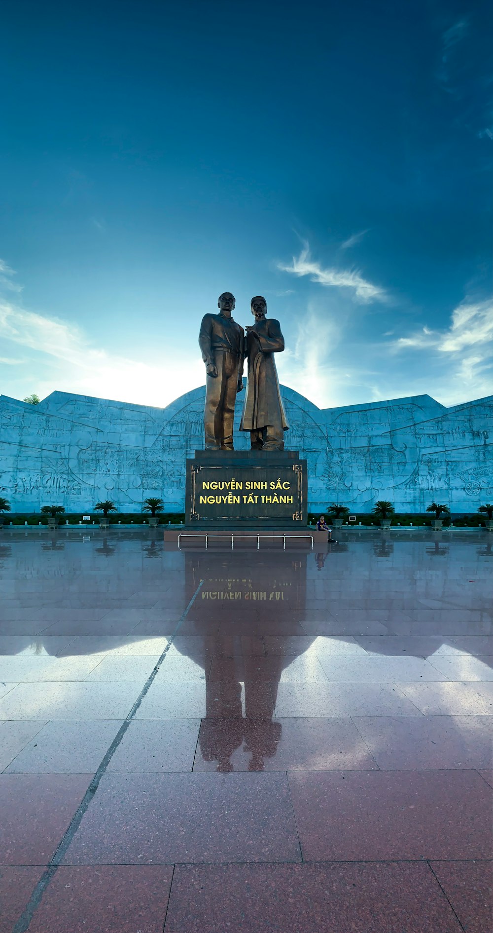 a statue of a man and a woman on a podium