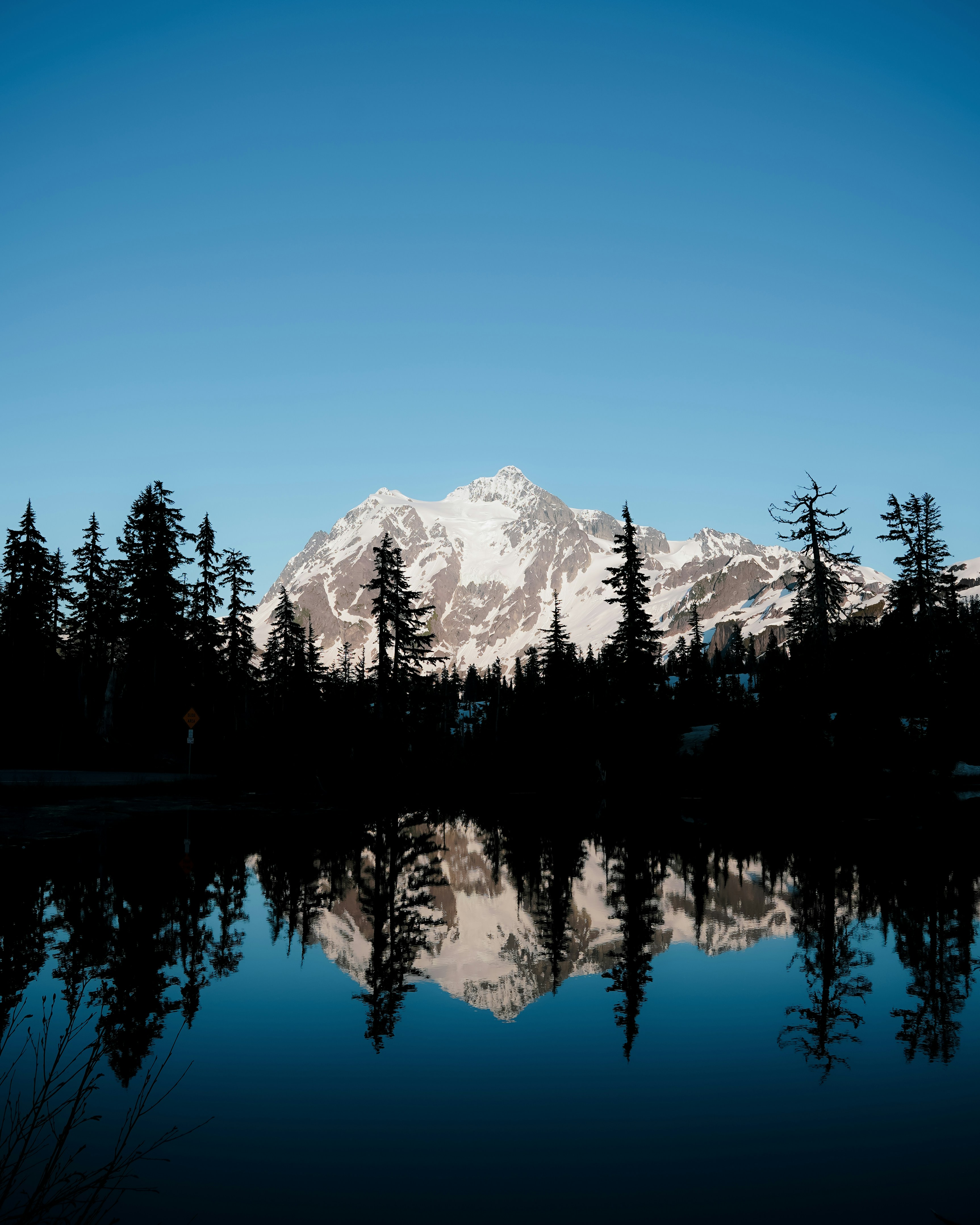 a snowy mountain reflected in water