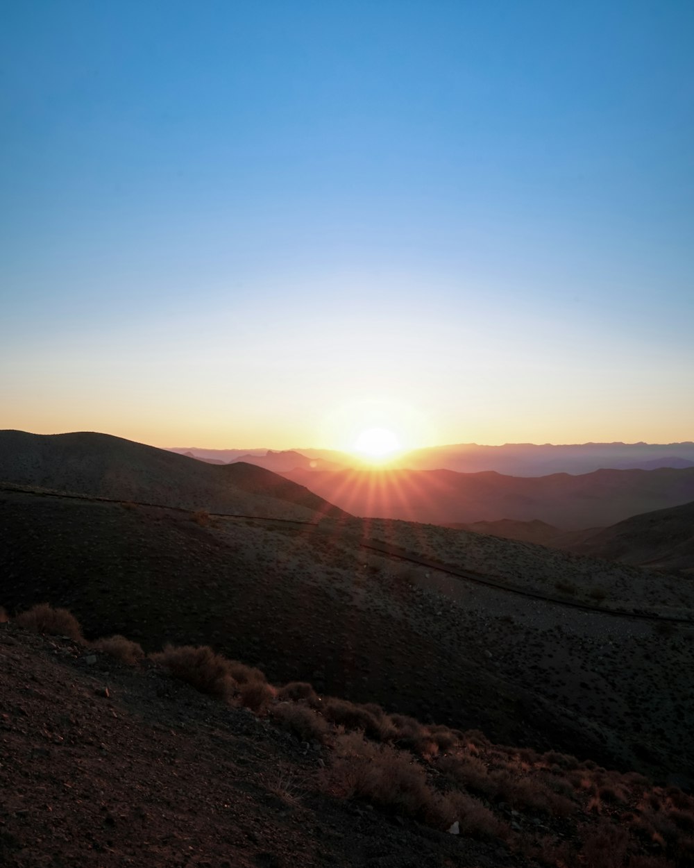 a sunset over a mountain