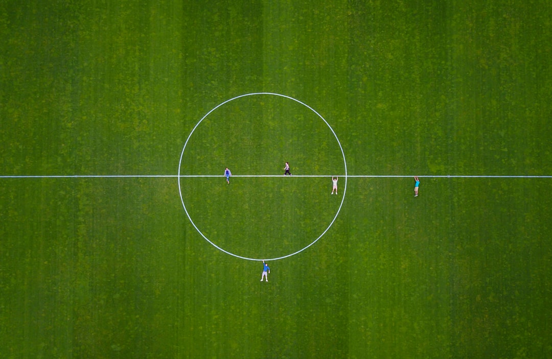 a group of people playing football,
