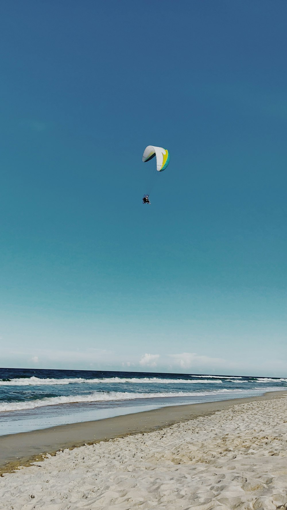 a person parasailing on a beach