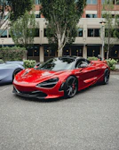 Sporty red coupe gleaming in a modern urban setting.