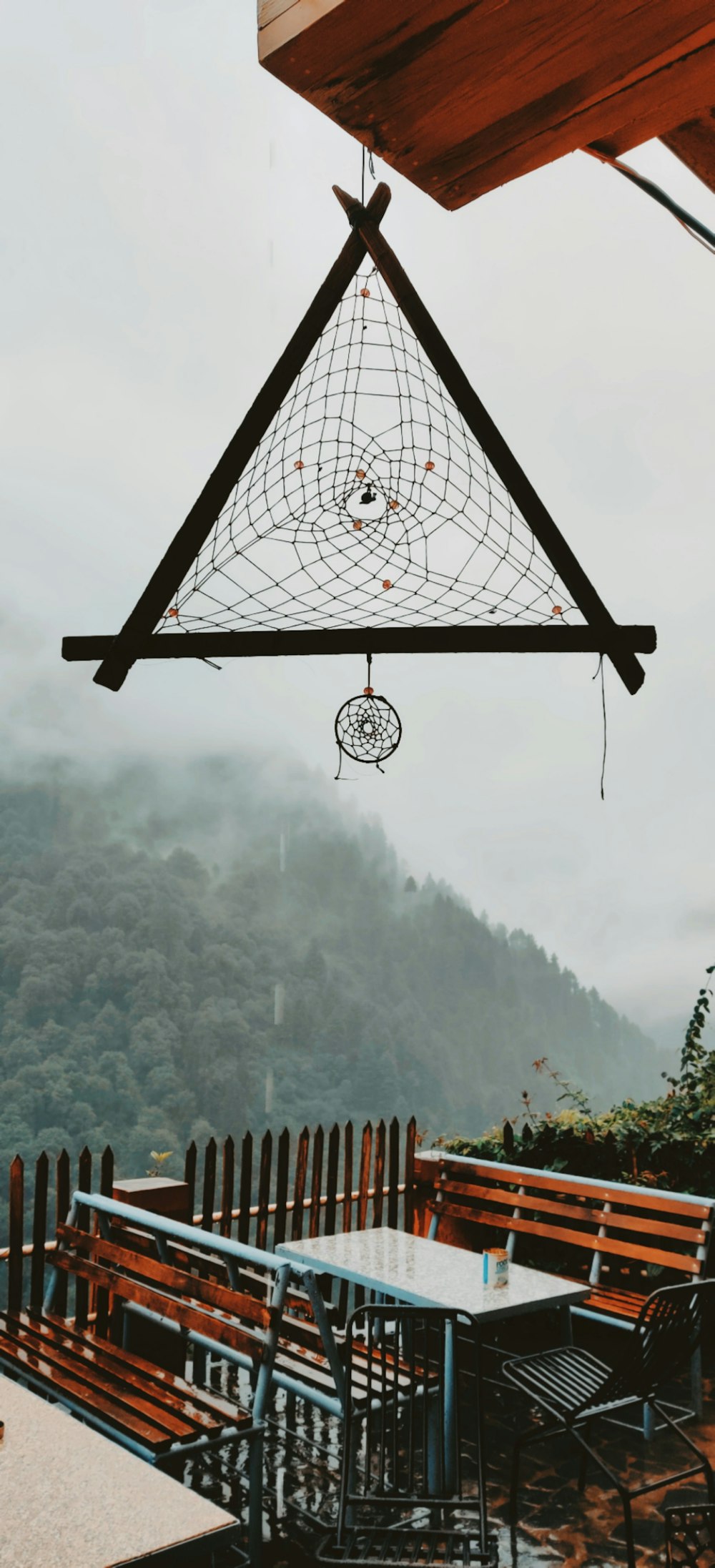 a large metal structure with a railing and trees in the background