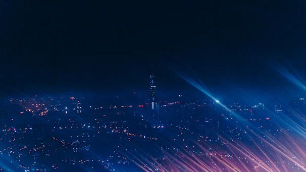 Wide shot of Manhattan skyline glowing at night, setting the scene for nocturnal adventures.