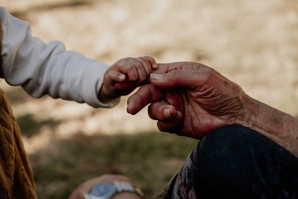 a close-up of hands shaking