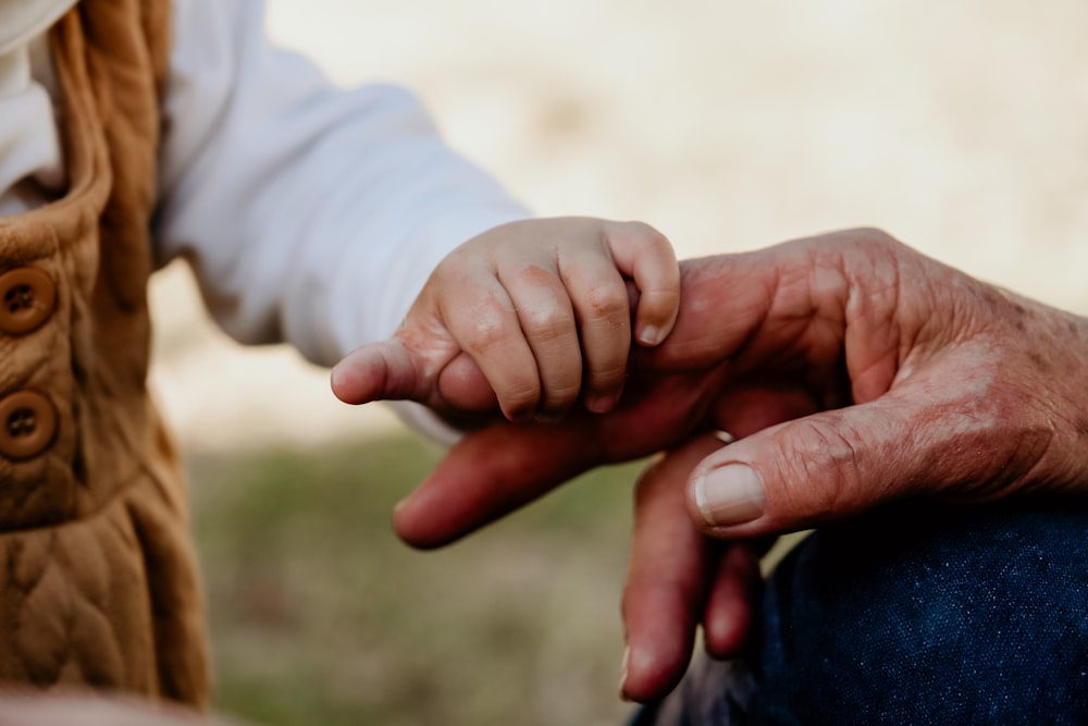 a close-up of hands shaking