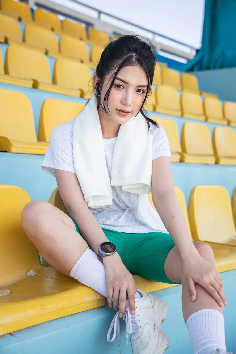 a person sitting on a yellow bench