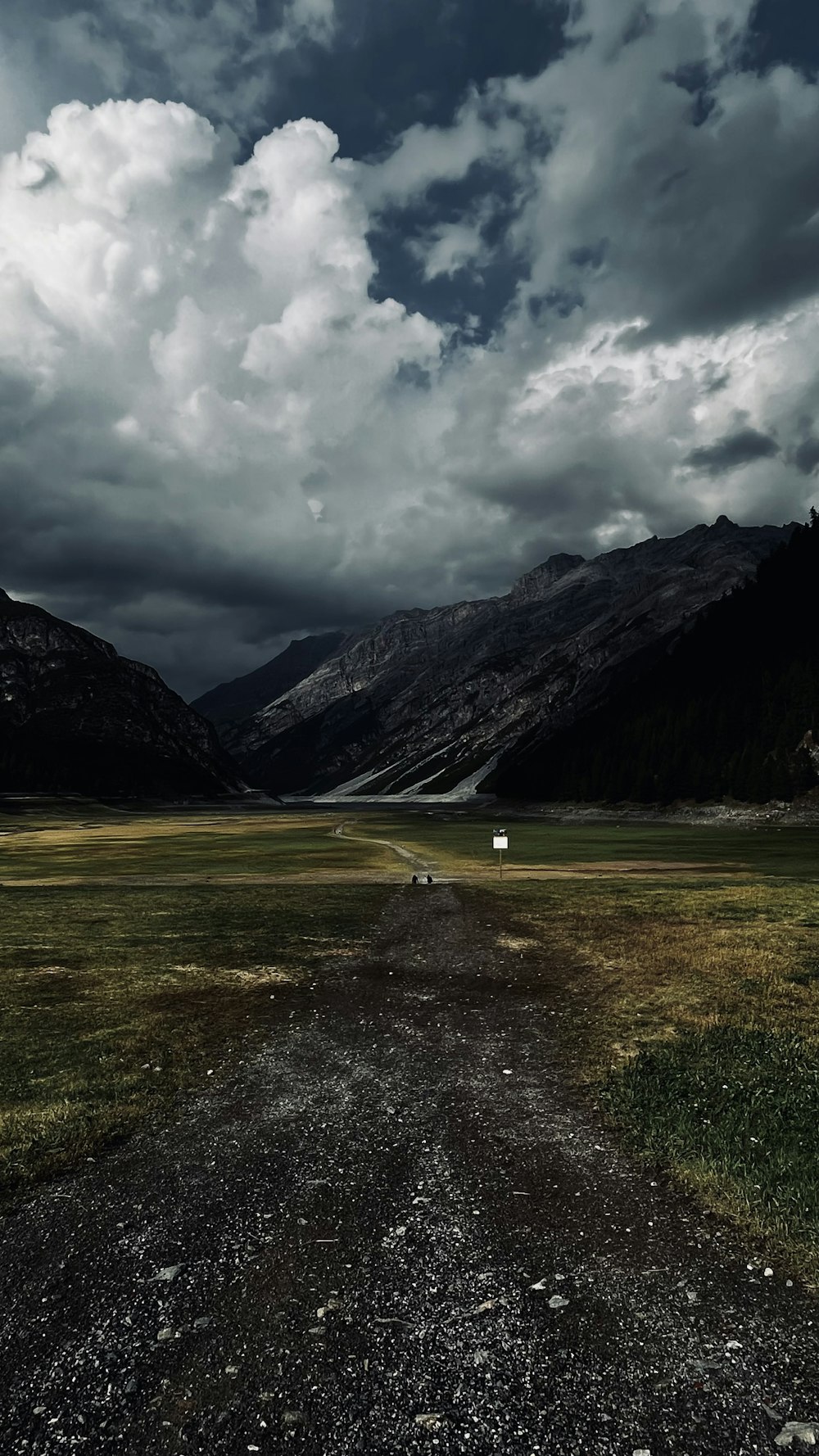 a landscape with mountains and clouds