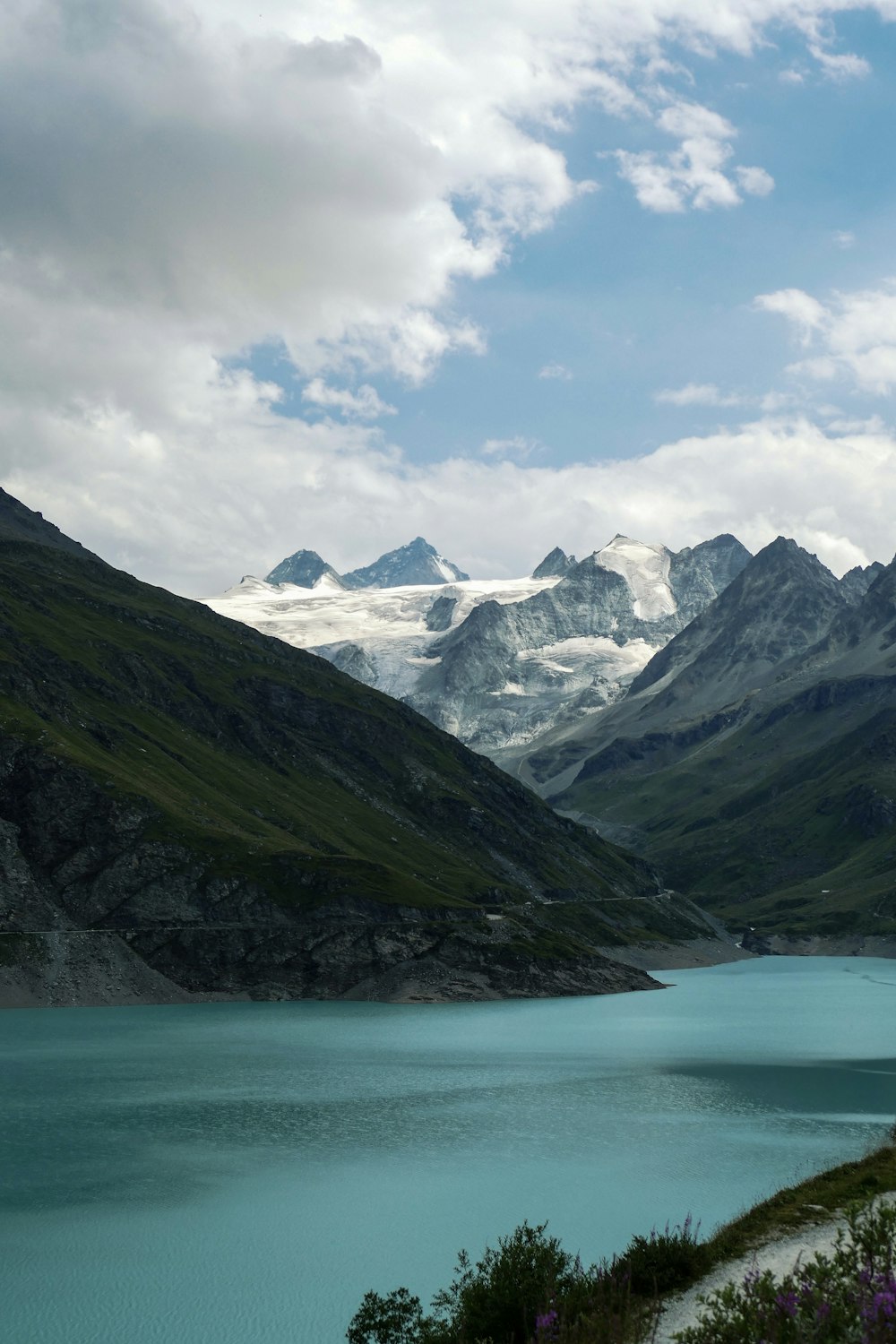 a body of water with mountains in the back