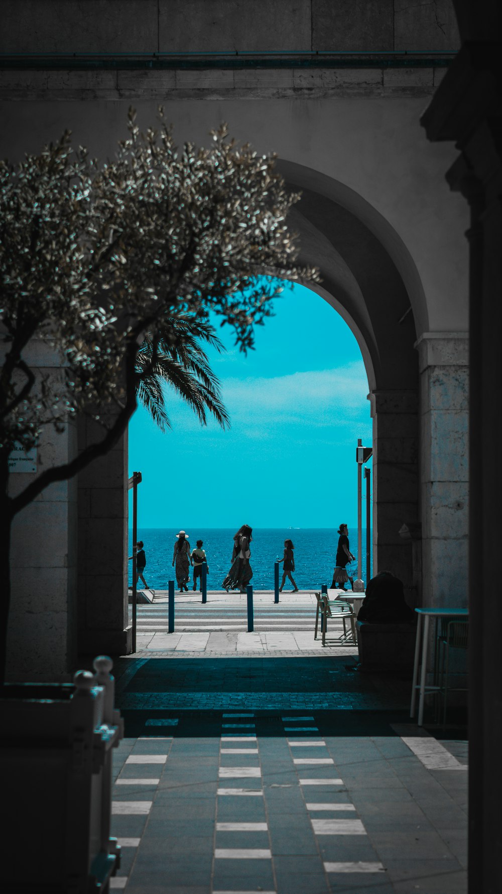 a group of people walking under a bridge