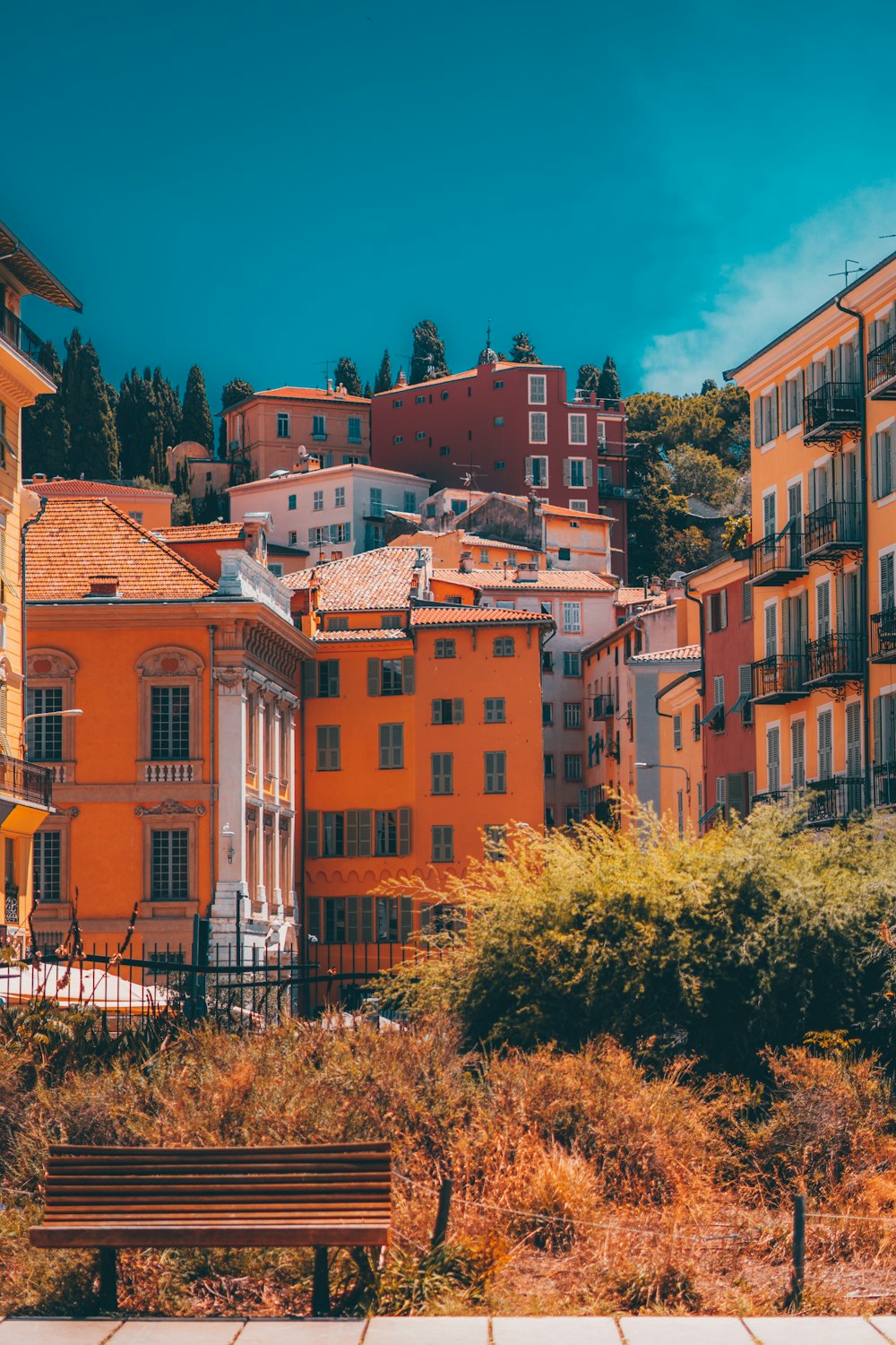 a bench in front of a group of buildings