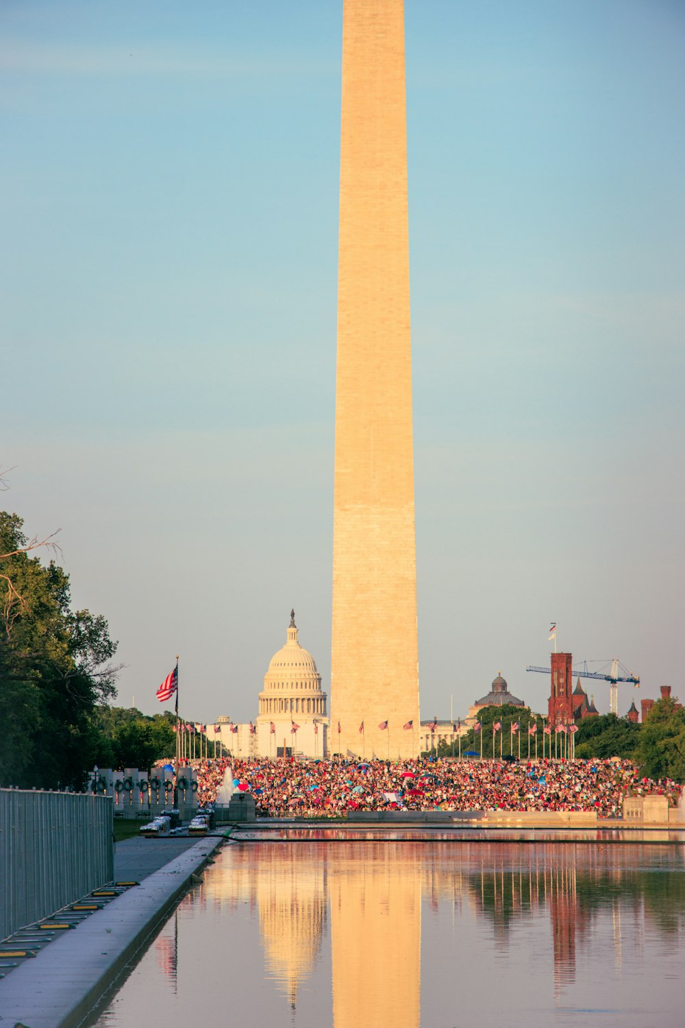 a tall monument with a building in the background