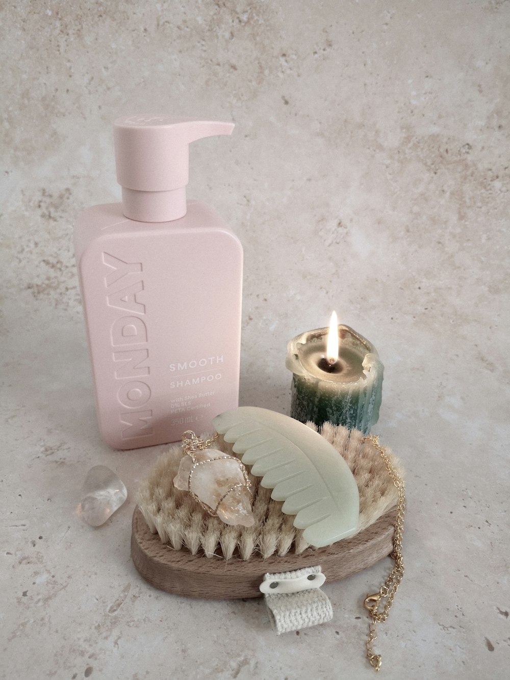 a basket of seashells and a candle on a marble counter