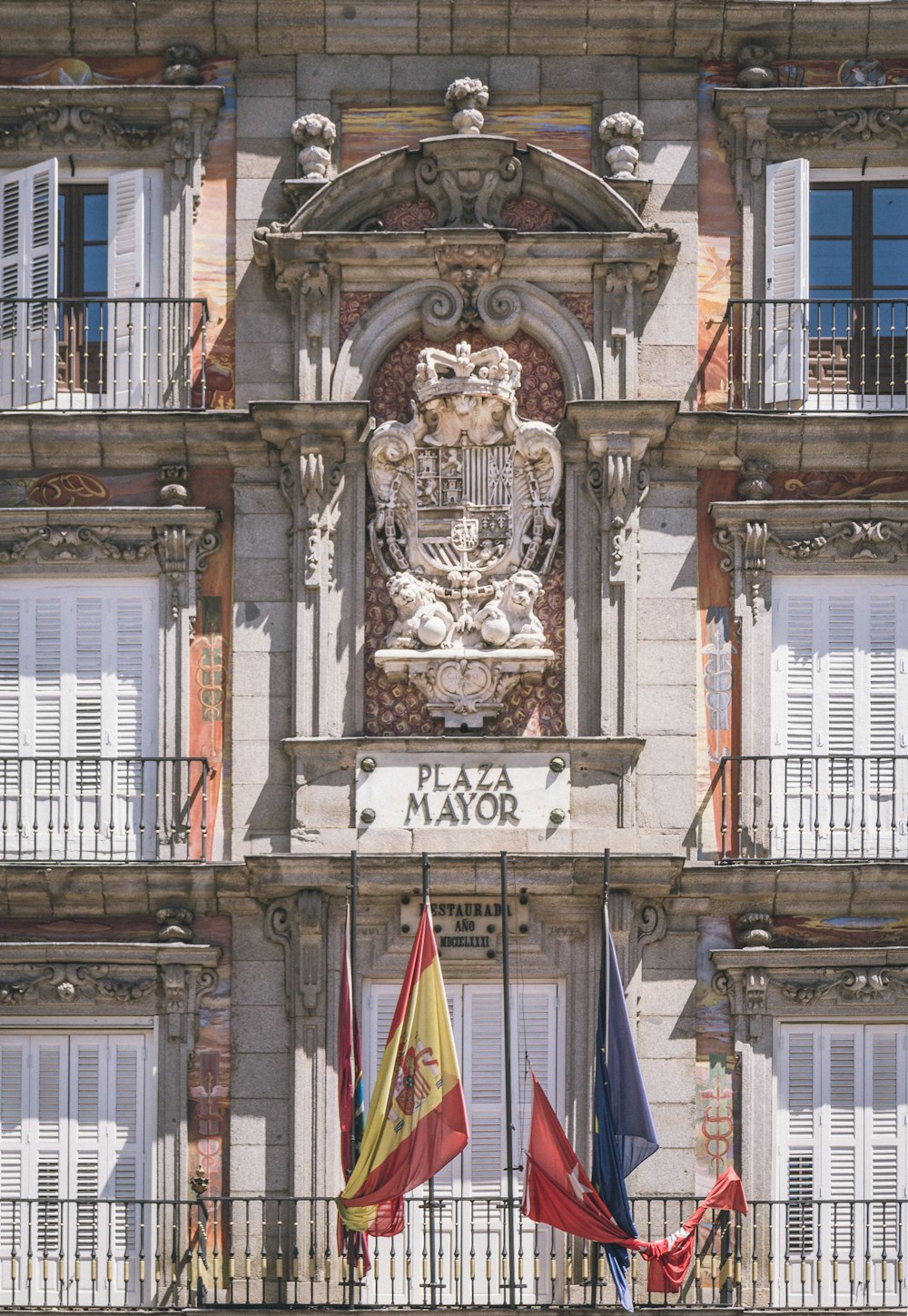 a building with a statue and flags