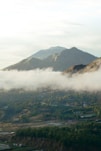 a valley with a town in it and mountains in the back