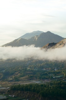 a valley with a town in it and mountains in the back