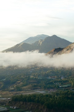 a valley with a town in it and mountains in the back