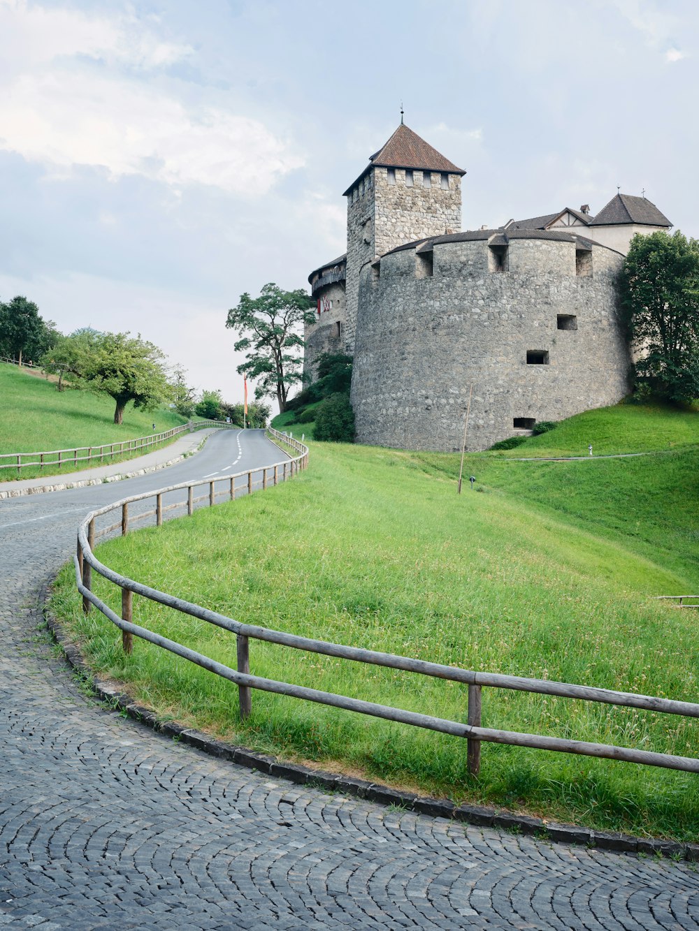 a stone castle with a fence