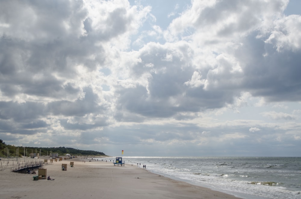 a beach with a pier and a body of water