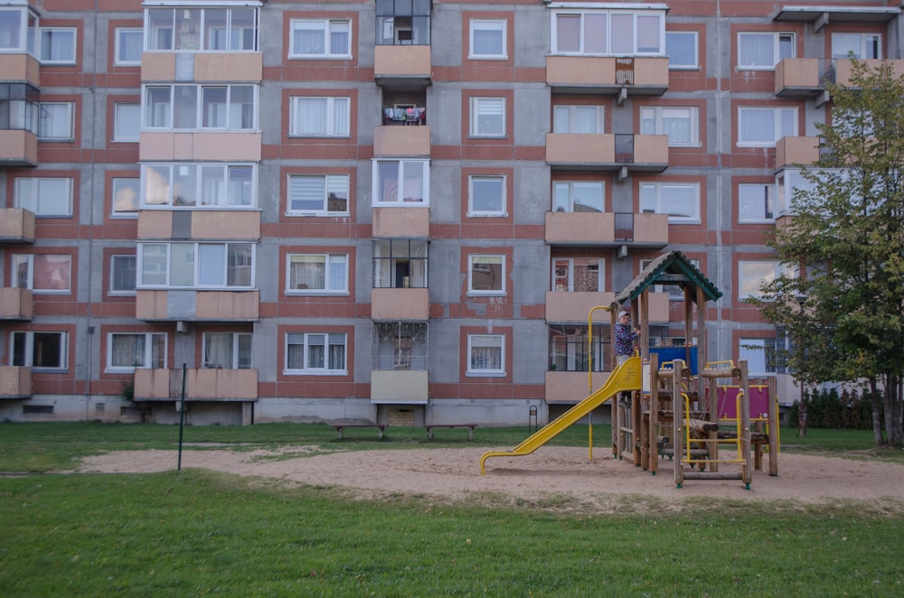a person on a playground in front of a building