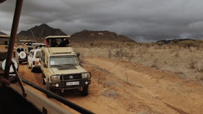 a group of vehicles on a dirt road
