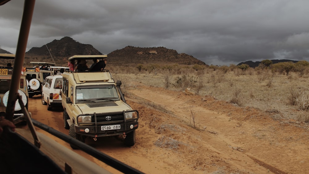 a group of vehicles on a dirt road