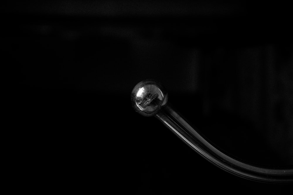 a silver spoon with a black background